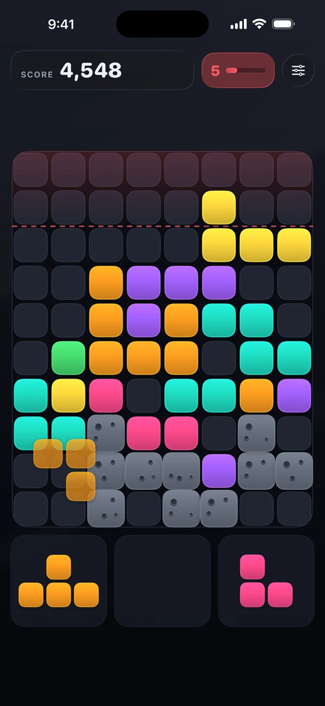 A board stacked past the dashed red danger line, the rubble clock badge turned red, and blocks reaching the second row from the top.